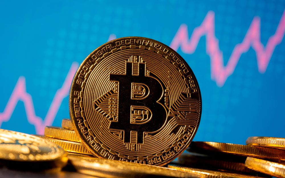 A representation of virtual currency Bitcoin is seen in front of a stock graph in this illustration taken November 19, 2020. u00e2u20acu201d Reuters pic 