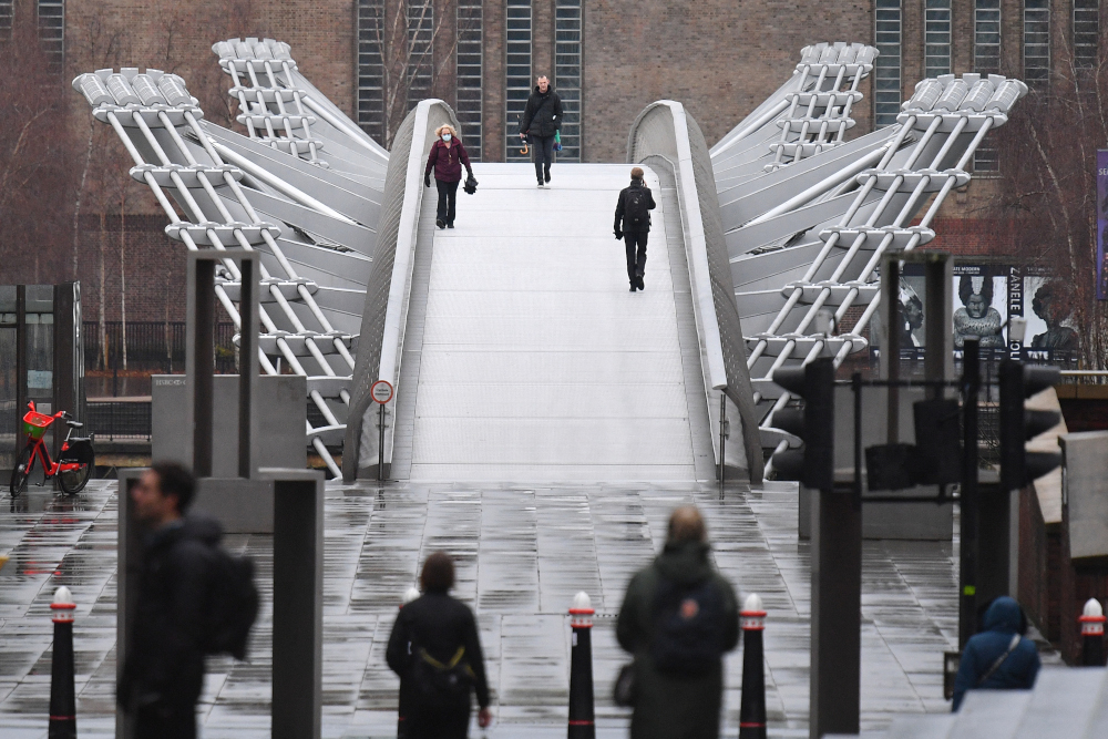 People walk across Millennium bridge in central London as Britain is in its third lockdown due to the coronavirus January 12, 2021. u00e2u20acu201d AFP picnn