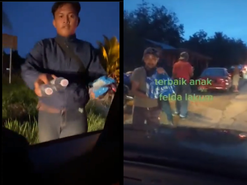Villagers of Felda Lakum handing out food supplies to those caught in traffic after the closure of East Coast Expressway due to floods. u00e2u20acu201d Screenshot from Twitter/AbenHazd
