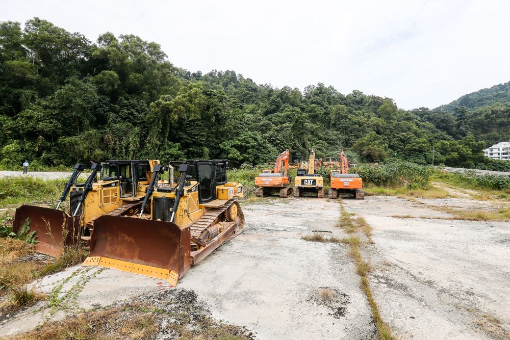 Workers unload heavy machinery onto the construction site of the Air Itam- Tun Dr Lim Choong Eu Expressway bypass in Gelugor January 19, 2021. u00e2u20acu201d Picture by Sayuti Zainudin