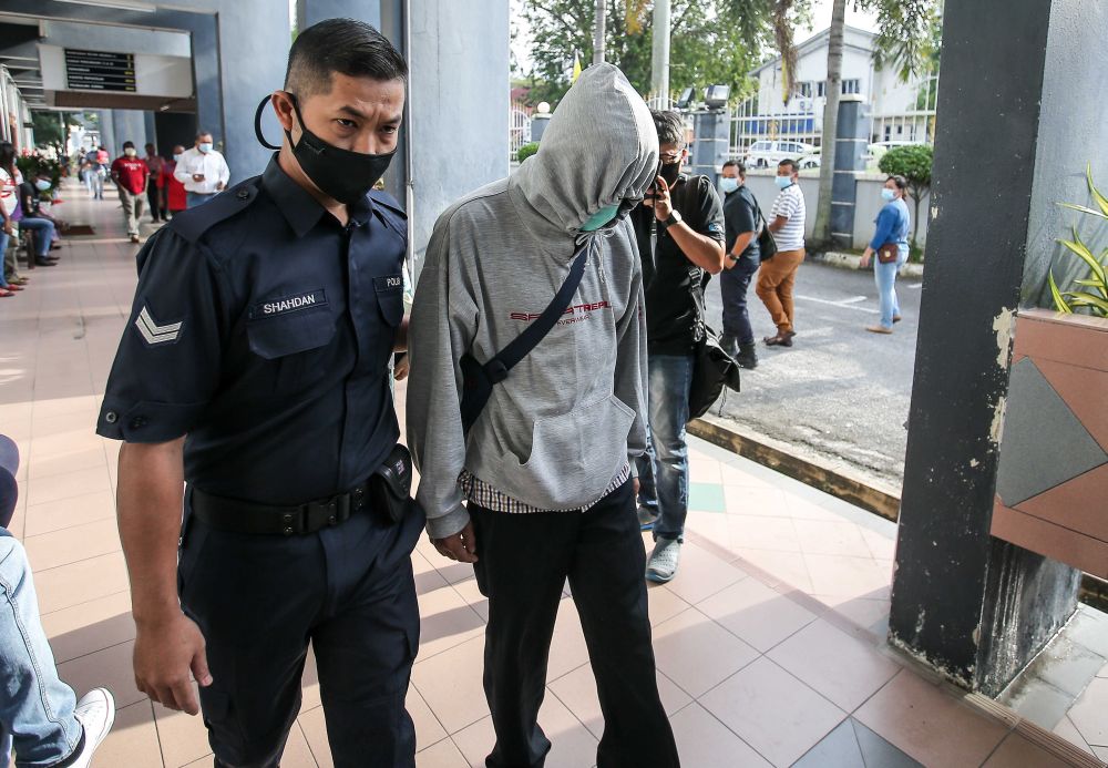A 42-year-old civil servant accused of molesting his daughters arrives at the at the Ipoh Sessions Court January 19, 2021. u00e2u20acu201d Picture by Farhan Najib