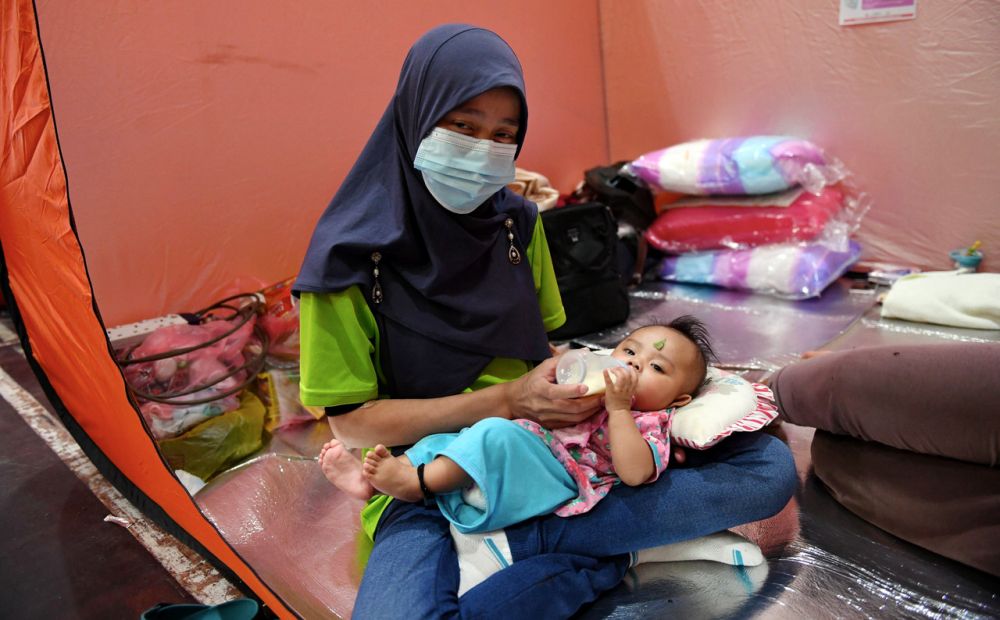 nA woman nurses her child at a flood relief centre in Kota Belud January 18, 2021. u00e2u20acu201d Bernama picn