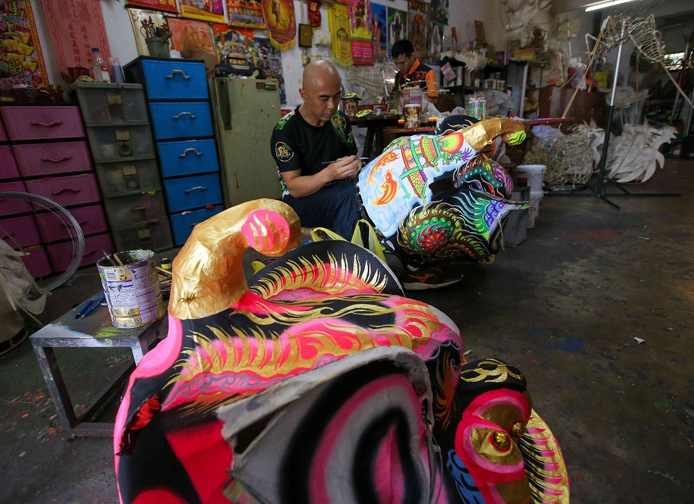 Teh working on a lion head at his shop at Jalan Bunga Saroja in Taman Melor.