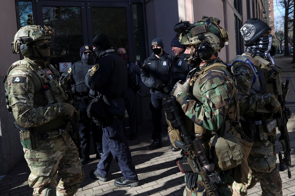 Armed people gather in front of law enforcement officers, outside the Virginia State Capitol on Lobby Day, a day traditionally set aside for the public to lobby lawmakers, in Richmond, Virginia January 18, 2021. u00e2u20acu2022 Reuters pic