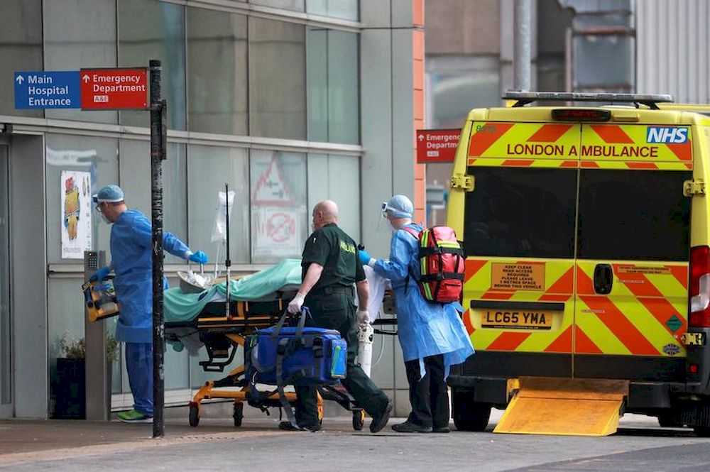 Medics transport a patient from an ambulance to the Royal London Hospital as the spread of the coronavirus disease (Covid-19) continues in London, Britain, January 1, 2021. u00e2u20acu201dReuters pic
