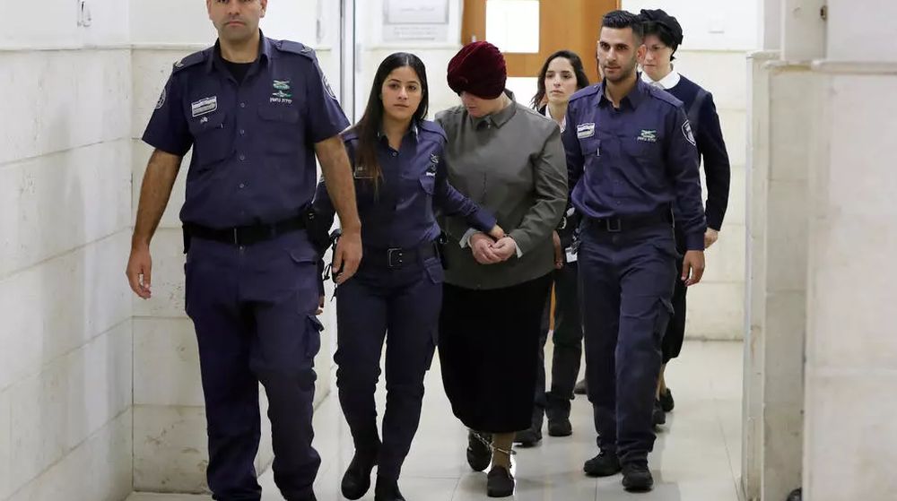 Malka Leifer (centre), a former Australian teacher accused of dozens of cases of sexual abuse of girls at a school, is escorted by police as she arrives for a court hearing. u00e2u20acu201d AFP pic