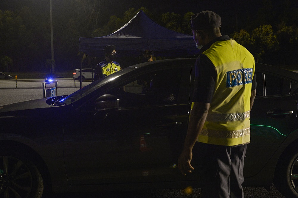 Police man a roadblock on the first day of the movement control order (MCO) in Shah Alam January 13, 2021. u00e2u20acu2022 Picture by Miera Zulyana