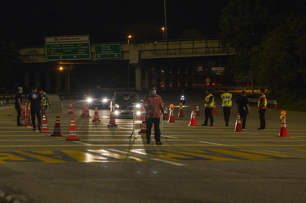 Police man a roadblock on the first day of the movement control order (MCO) in Shah Alam January 13, 2021. u00e2u20acu2022 Picture by Miera Zulyana