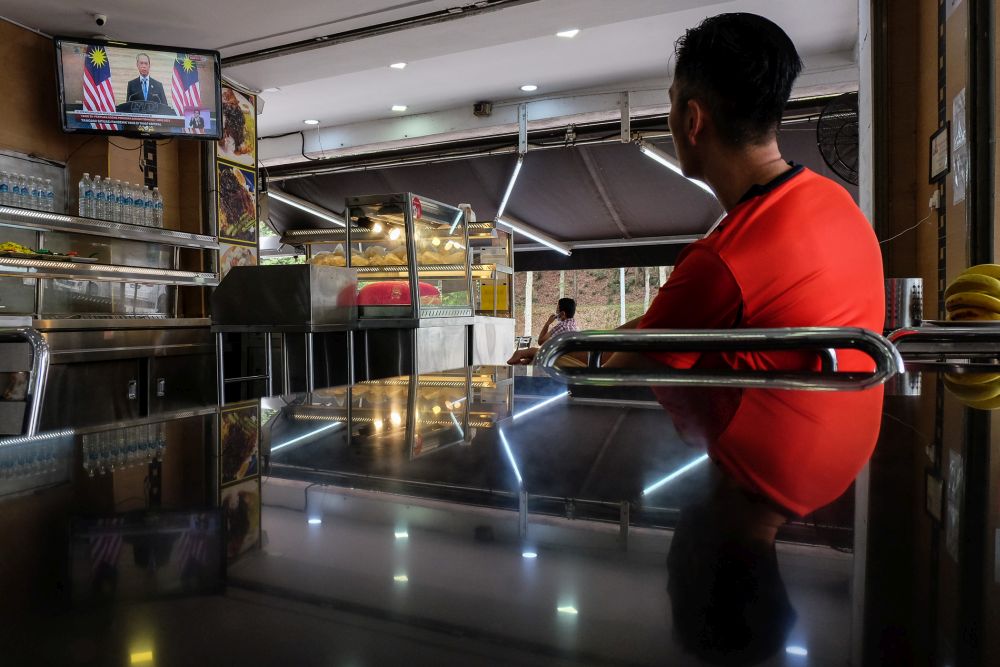 A man watches a live telecast of Prime Minister Tan Sri Muhyiddin Yassin's speech at a restaurant in Shah Alam January 12, 2020. u00e2u20acu201d Picture by Yusof Mat Isa