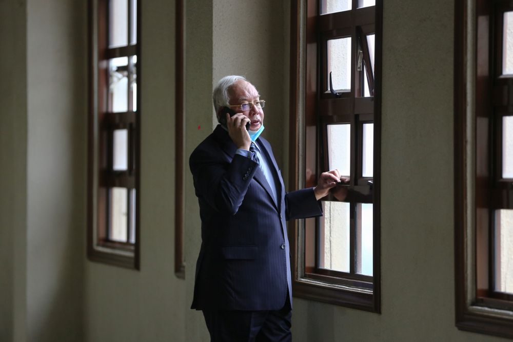 Datuk Seri Najib Razak speaks on his phone at the Kuala Lumpur High Court January 6, 2021.  u00e2u20acu201d Picture by Yusof Mat Isa