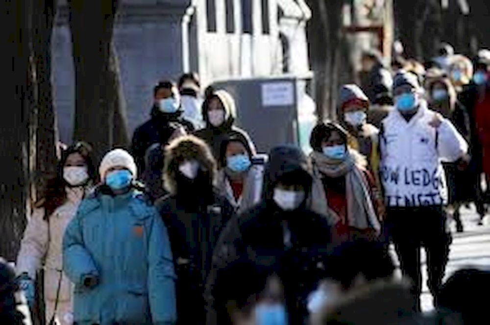 People wearing protective face masks walk along Nanluoguxiang alley, following the coronavirus disease (Covid-19) outbreak, in Beijing, China January 16, 2021. u00e2u20acu201d Reuters pic