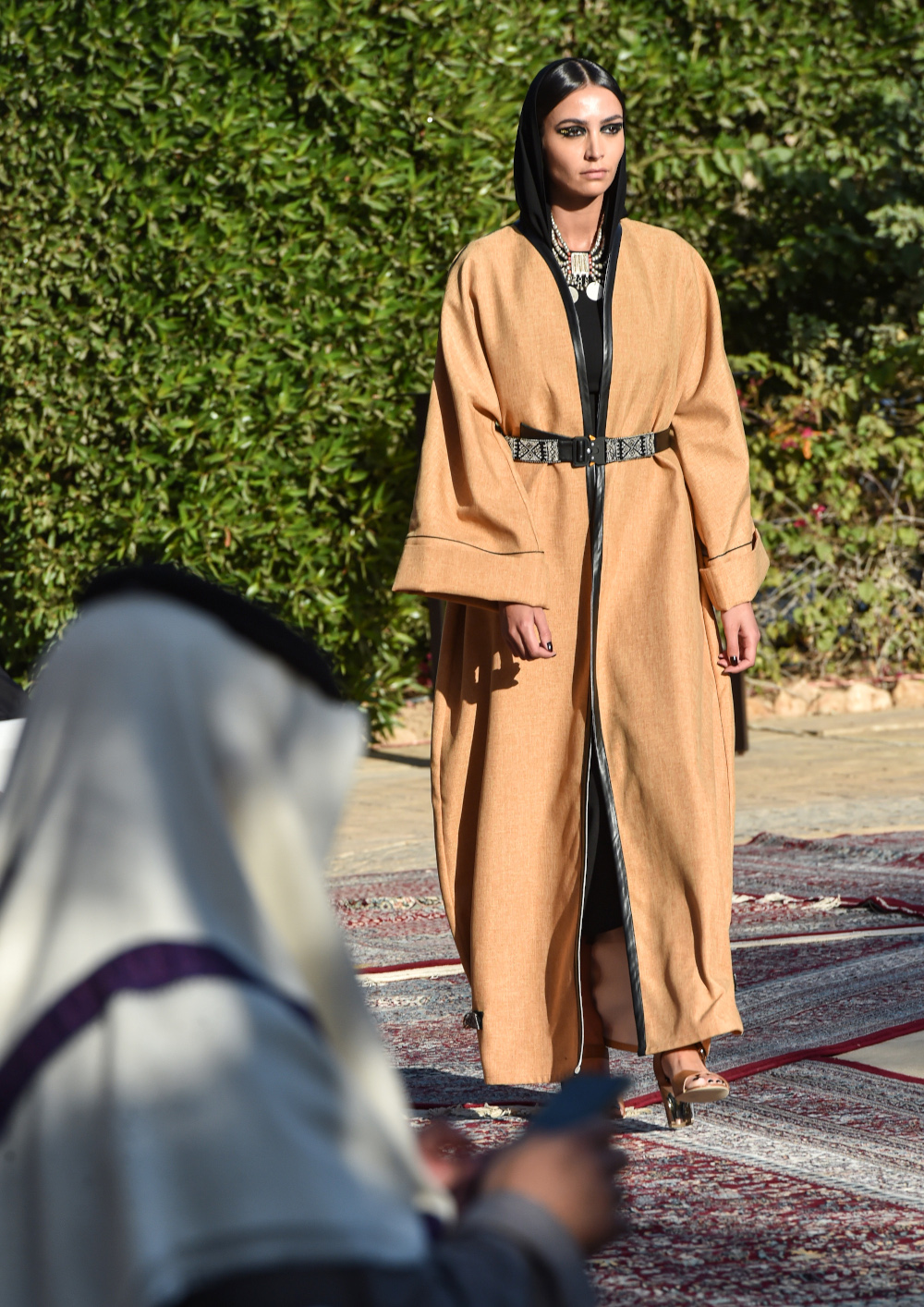Donning chic neck-to-toe abayas, models saunter in high heels around a swimming pool, in a glitter-filled fashion show in the unlikeliest of venues: Saudi Arabia. — AFP pic 