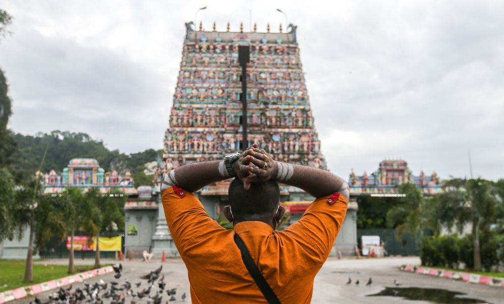 A Hindu devotee prays at the Kallumalai Arulmigu Subramaniyar Temple in Ipoh during Thaipusam January 28, 2021. u00e2u20acu201d Picture by Farhan Najib