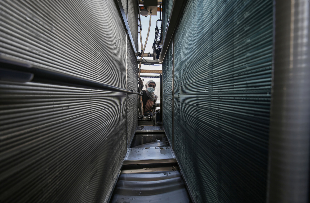 Palestinian engineer Nadia Tubail checks the filters a solar-powered water generator that extracts potable water straight from the air donated by Watergen in Khan Yunis, southern Gaza Strip, November 16, 2020. u00e2u20acu201d AFP pic 