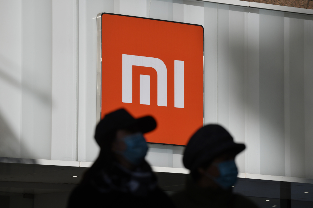 Two women walk past a Xiaomi store in Beijing January 15, 2021, as shares in the company collapsed on January 15 after the United States blacklisted the smartphone giant and a host of other Chinese firms. u00e2u20acu201d AFP pic 