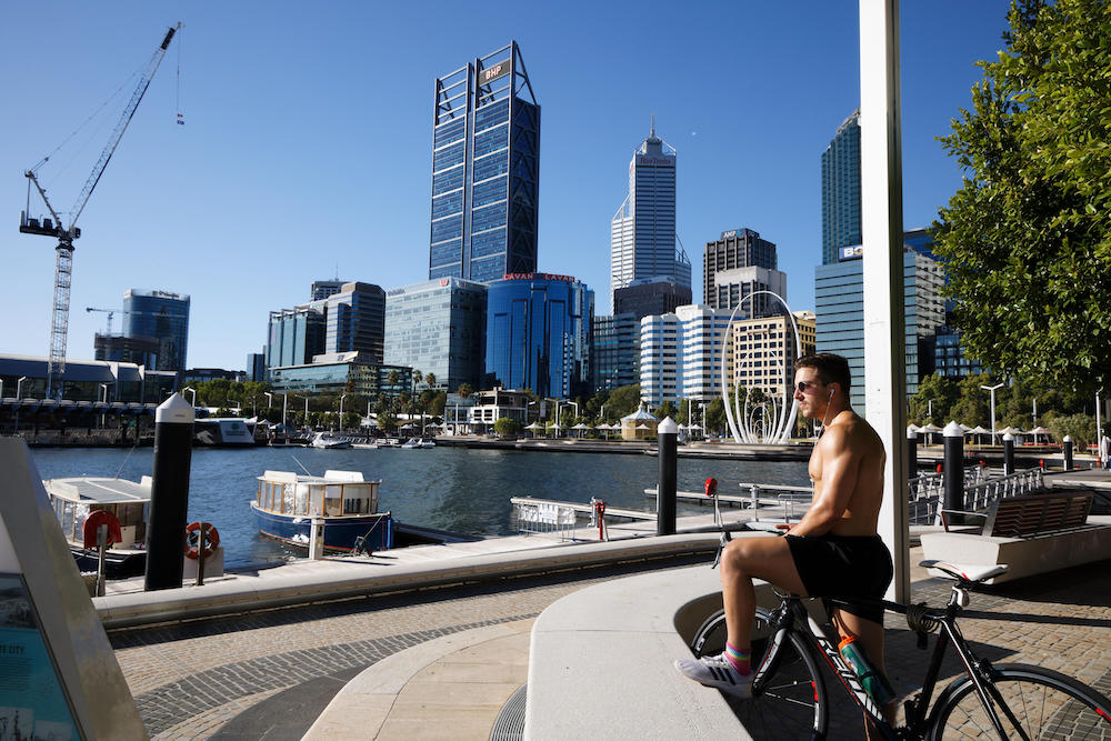 A cyclist looks out over the normally busy Elizabeth Quay area in Perth on January 31, 2021, as authorities announced a snap five-day lockdown after a security guard at a quarantine hotel tested positive for Covid-19. u00e2u20acu201d AFP pic