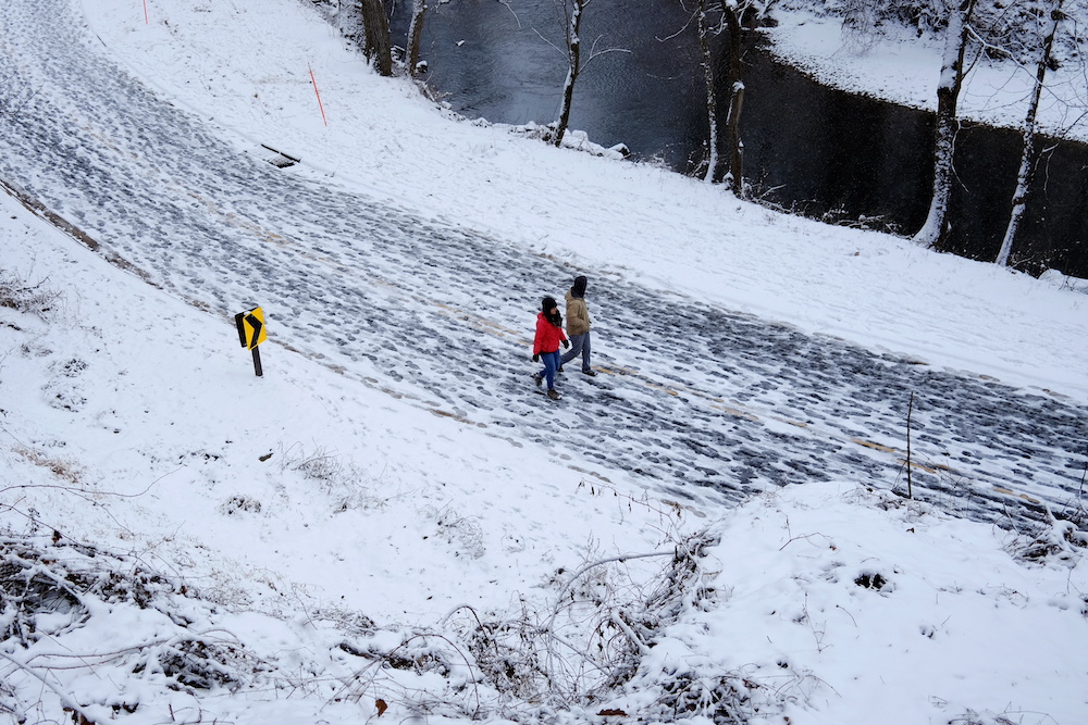 Local residents walks along a road in Rock Creek park after a snow storm in Washington January 31, 2021. u00e2u20acu201d Reuters pic