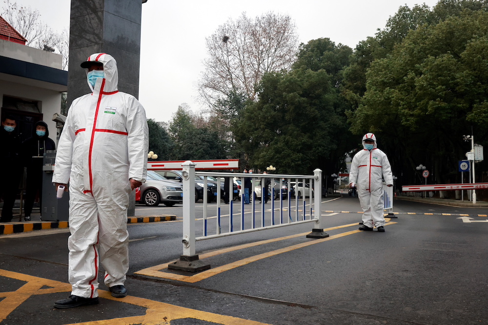 Security personnel in personal protective equipment (PPE) look on during the visit by members of the World Health Organization (WHO) team at the Hubei provincial centre for disease control in Wuhan, China February 1, 2021. u00e2u20acu201d Reuters pic