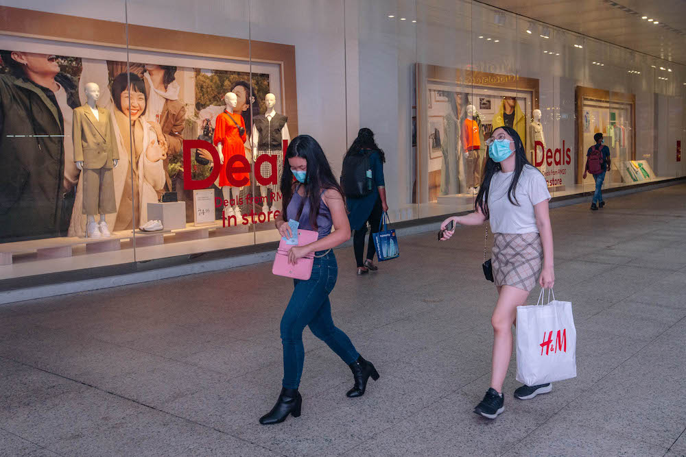 People wearing facemasks are seen walking outside a shopping mall in Kuala Lumpur amid the Covid-19 outbreak, February 16, 2021. — Picture by FIrdaus Latif