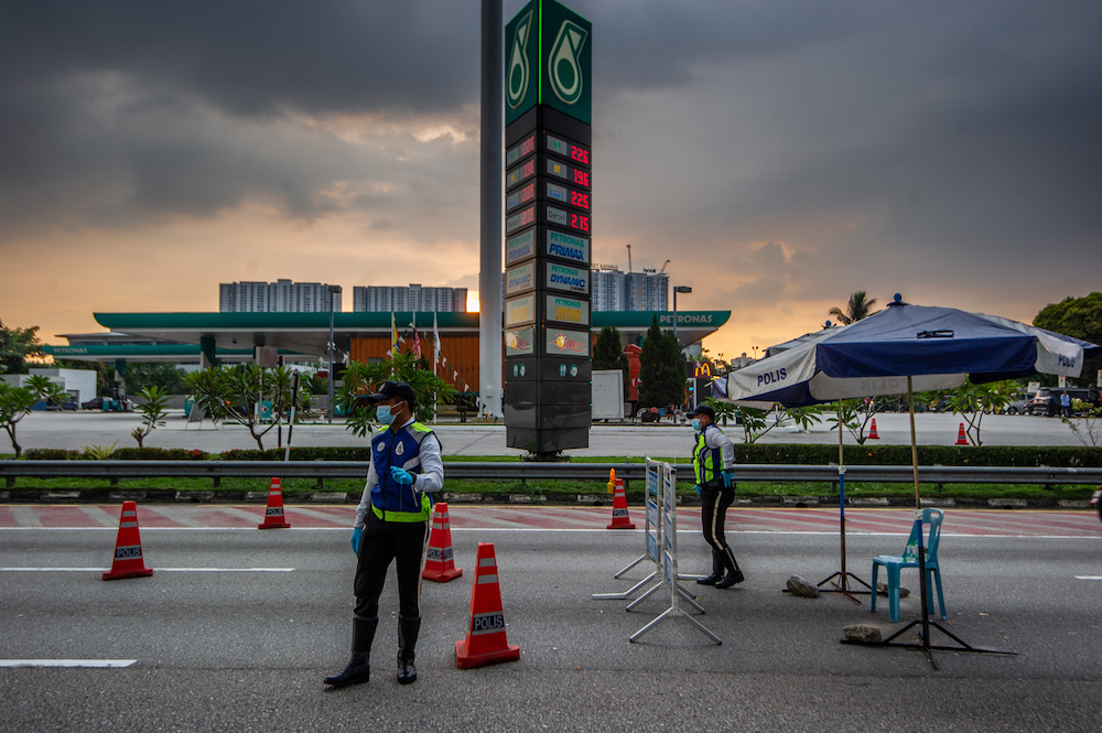 Police officers conducting checks at a roadblock in Sungai Besi, Kuala Lumpur February 16, 2021. u00e2u20acu201d Picture by Shafwan Zaidon