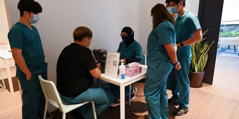 Health staff prepare polymerase chain reaction (PCR) test-kit for guests at the Connect@Changi. u00e2u20acu201d AFP pic