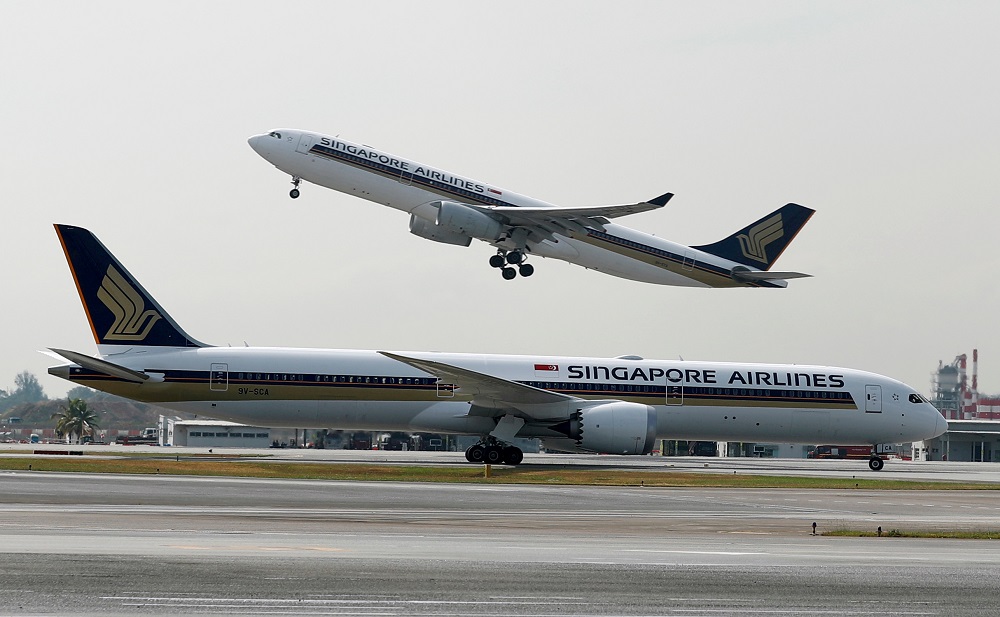 A Singapore Airlines Airbus A330-300 plane takes off behind a Boeing 787-10 Dreamliner at Changi Airport in Singapore March 28, 2018. u00e2u20acu201d Reuters pic