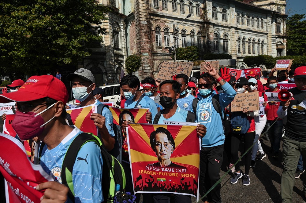 Demonstrators march with signs to protest against the military coup and demand for the release of elected leader Aung San Suu Kyi, in Yangon February 12, 2021. u00e2u20acu201d Reuters pic
