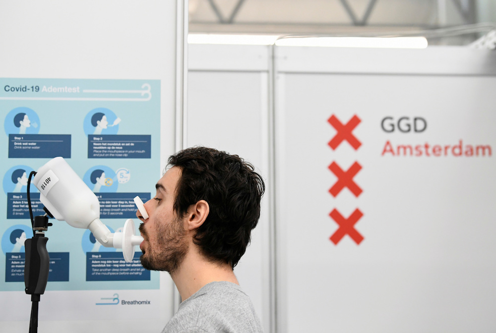 A man demonstrates how a Covid-19 breath test works in the testing facilities in the Netherlands that will be equipped with breath tests capable of giving immediate results in Amsterdam, Netherlands February 1, 2021. u00e2u20acu201d Reuters picnn