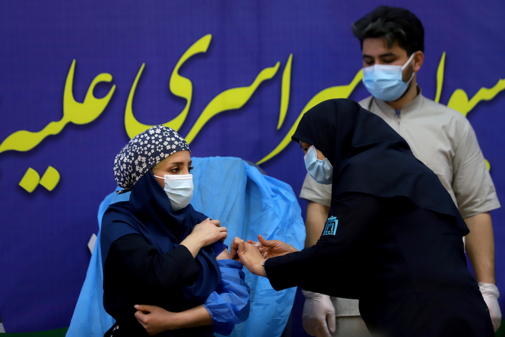 A member of the Imam Khomeini Hospital medical personnel receives a dose of Russiau00e2u20acu2122s Sputnik V vaccine against the coronavirus disease (Covid-19), in Tehran, Iran February 9, 2021. u00e2u20acu201d Majid Asgaripour/WANA (West Asia News Agency) via Reuters picnn