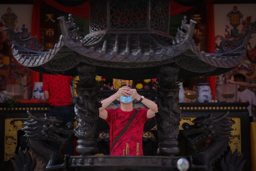A worshipper wearing a protective mask prays during the Chinese New Yearu00e2u20acu2122s Eve at the Thean Hou Temple in Kuala Lumpur February 11, 2021. u00e2u20acu201d Picture by Yusof Mat Isa