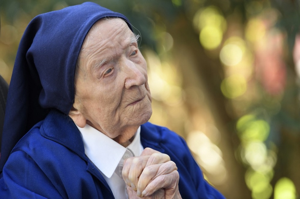 Sister Andre, Lucile Randon in the registry of birth, the eldest French and European citizen, prays as she sits in a wheelchair, on the eve of her 117th birthday. u00e2u20acu201d AFP pic