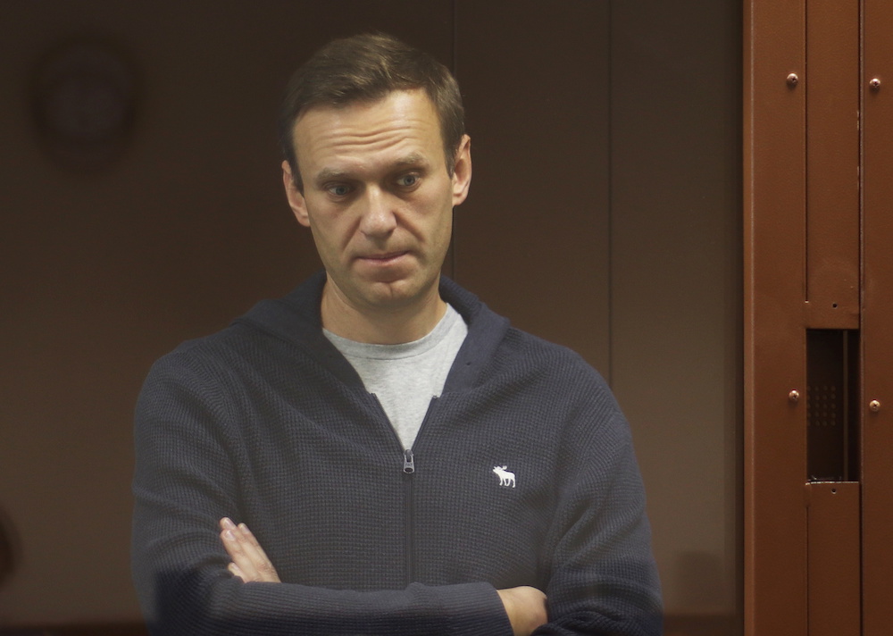 Kremlin critic Alexei Navalny, who is accused of slandering a Russian World War Two veteran, stands inside a defendant dock during a court hearing in Moscow, Russia, Russia February 12, 2021. u00e2u20acu201d Reuters picn n