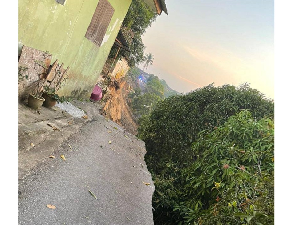 A photograph showing a large portion of Lorong Pohon Chelagi in Pasir Mas that collapsed into the river. u00e2u20acu201d Picture via Facebook/Ahmad Fadhli bin Shaari