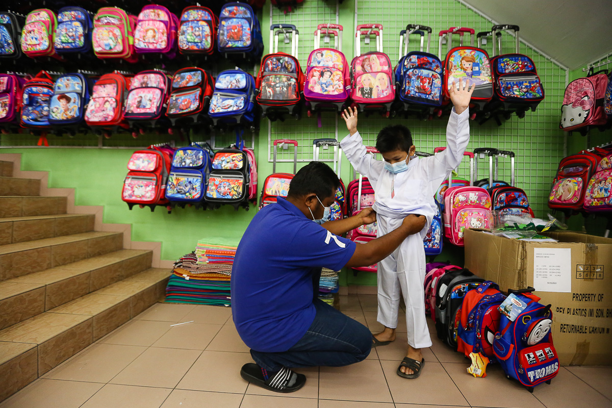 A parent shop for new school essentials for his child at Pusat Pakaian Hari-Hari in Shah Alam February 20, 2021. u00e2u20acu201d Picture by Yusof Mat Isa