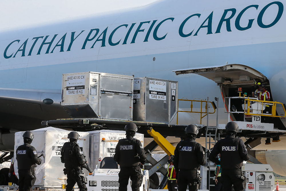 The first batch of Pfizer-BioNTech Covid-19 vaccine is moved into DHL transport van after arriving at Malaysia Airline Berhad (MAS) Penang Cargo Complex, Bayan Lepas on February 21, 2021. u00e2u20acu201d Picture by Sayuti Zainudin
