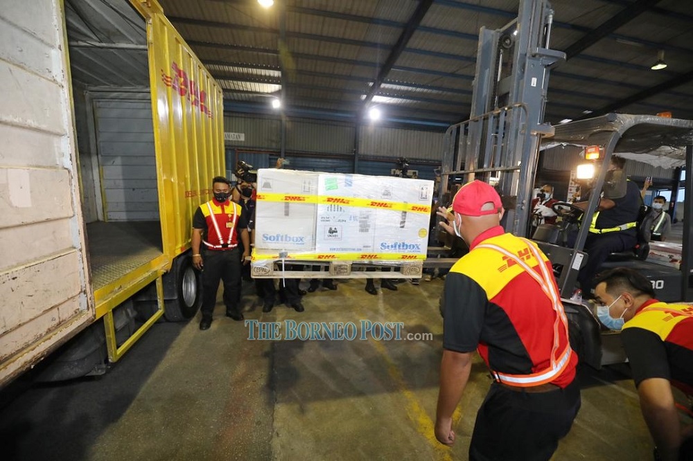 A DHL transport van is loaded up with the Pfizer-BioNTech vaccine upon its arrival at Kuching International Airport today. u00e2u20acu201d Borneo Post Online pic