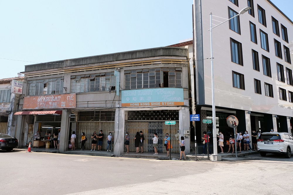 A long queue snaked from Tai Buan Porridge along Muntri Street to Leith Street as early as 11.30am in George Town February 24, 2021. u00e2u20acu201d Picture by Steven Ooi KE