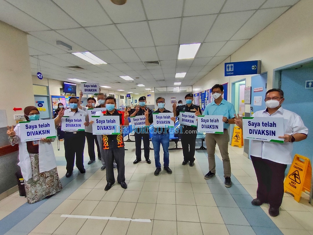 Dr Annuar (fourth right), posing with (from right) Sempurai, Lau, Stanley, Collin, Siaw, Ting, Dr Teh and Suhaili Mohamed after receiving their vaccination at Lanang Health Clinic, Sibu. u00e2u20acu201d Borneo Post Online pic