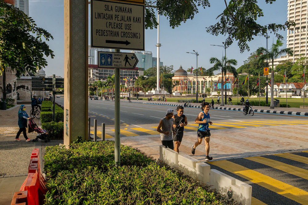 People are seen jogging along Dataran Merdeka in Kuala Lumpur February 21, 2021. u00e2u20acu201d Picture by Firdaus Latif