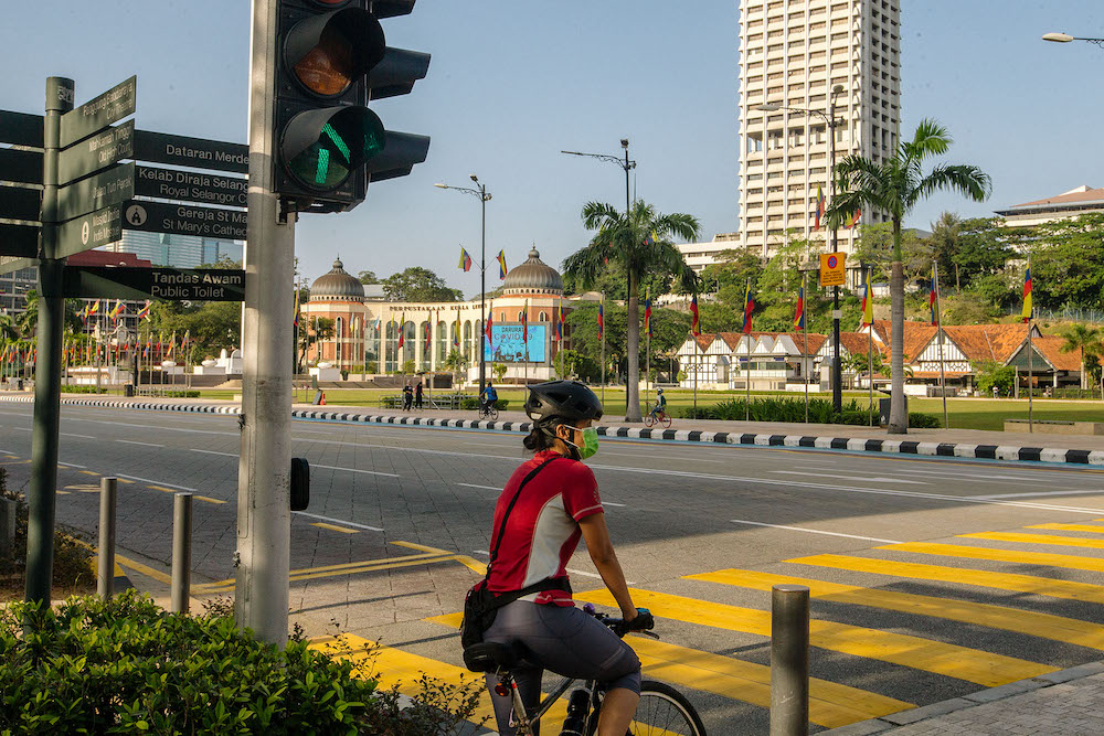 People are seen cycling along Dataran Merdeka in Kuala Lumpur February 21, 2021. u00e2u20acu201d Picture by Firdaus Latif