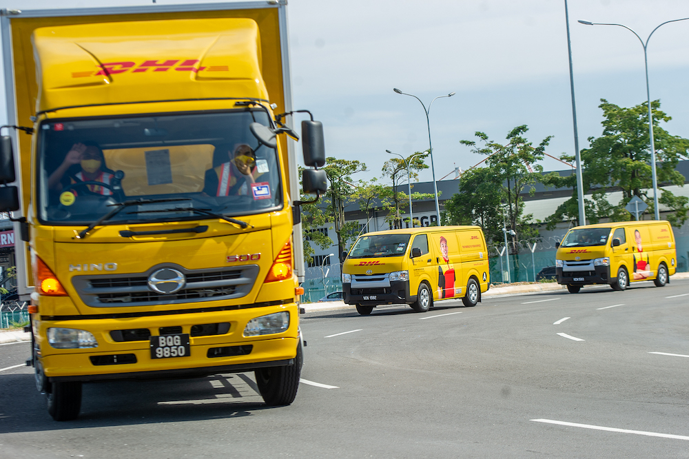 A convoy of DHL Express vehicles carry the first batch of Pfizer-BioNTech's Covid-19 vaccine with police escort from Cargo Village in KLIA, February 21, 2021. u00e2u20acu201d Picture by Shafwan Zaidon