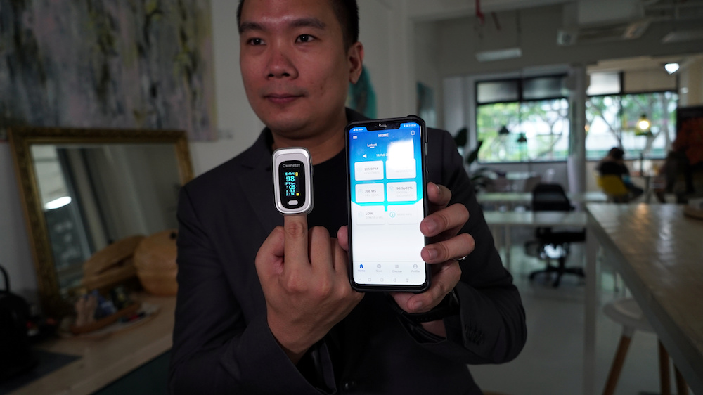 Nervotec founder Jonathan Lau shows the comparison in vital signs readings between his company's app and a pulse oxygen monitor, in Singapore February 19, 2021. u00e2u20acu201d Reuters pic