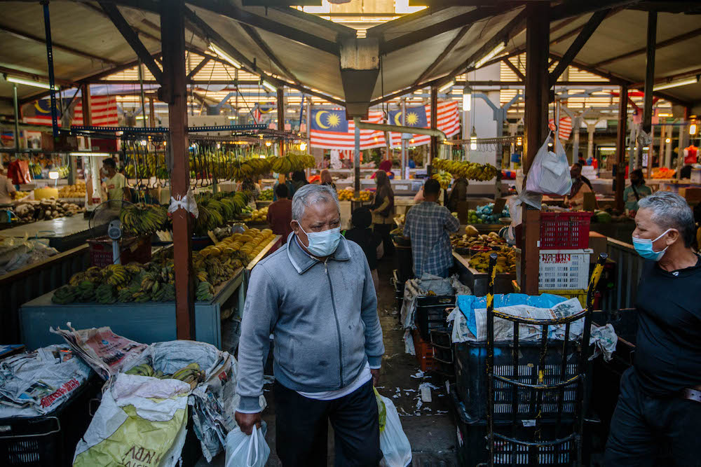 People wearing facemasks shop for groceries at Chow Kit market during the movement control order (MCO) in Kuala Lumpur February 28, 2021. u00e2u20acu201d Picture by Firdaus Latifu00e2u20acu00a8u00e2u20acu00a8