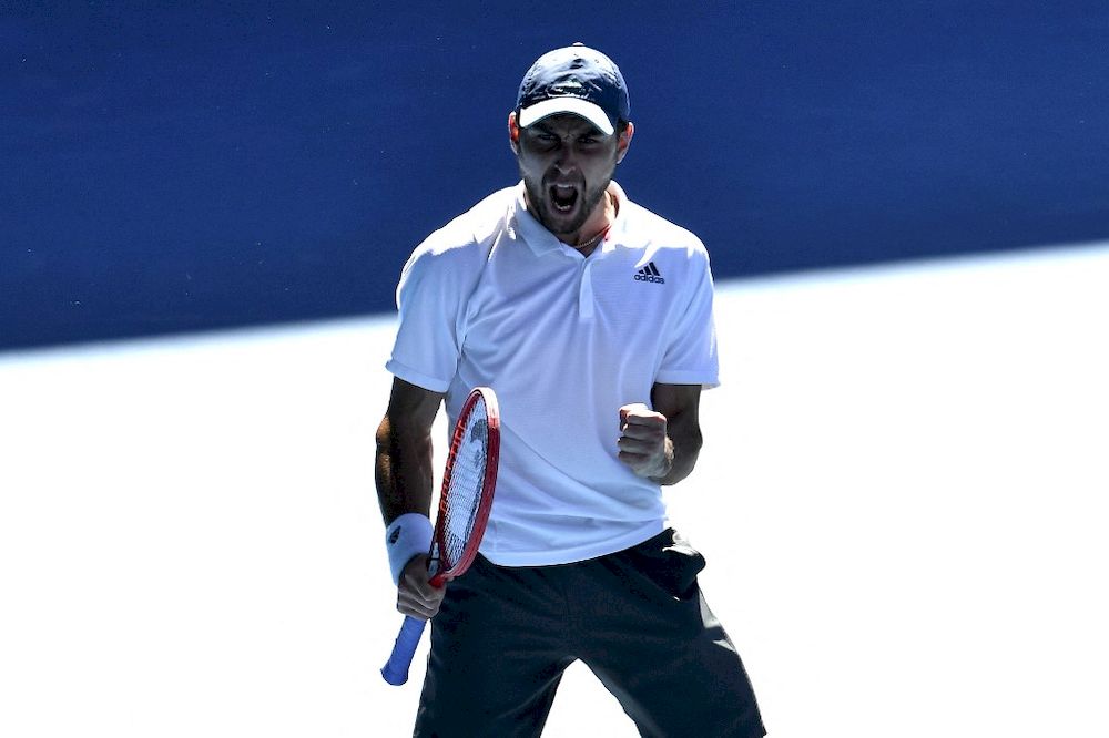 Russiau00e2u20acu2122s Aslan Karatsev celebrates the match point against Canadau00e2u20acu2122s Felix Auger-Aliassime during their menu00e2u20acu2122s singles match on day seven of the Australian Open tournament in Melbourne, February 14, 2021. u00e2u20acu201d AFP pic