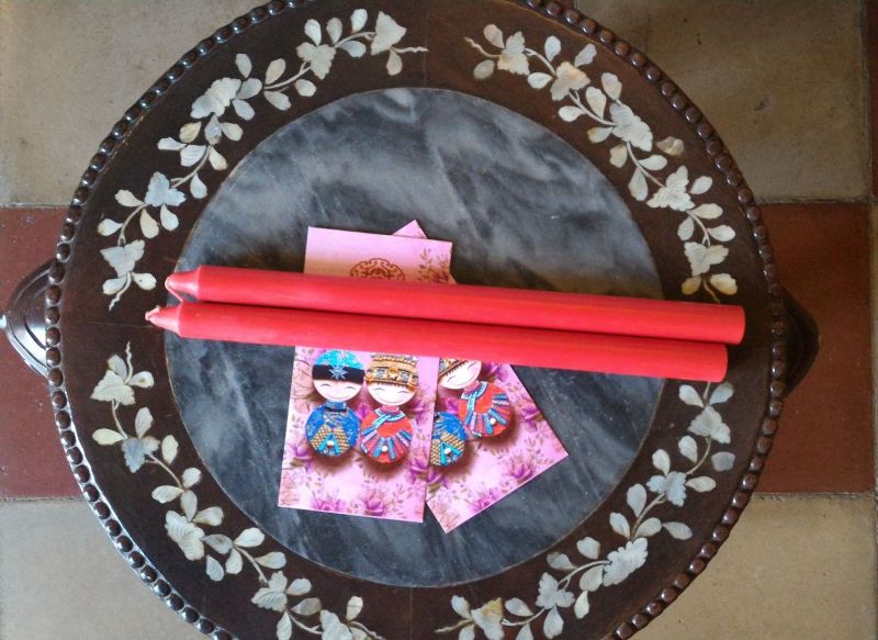 : A pair of red candles and angpows would be given to newly married couples on CNY. —Picture courtesy of Cedric Tan 