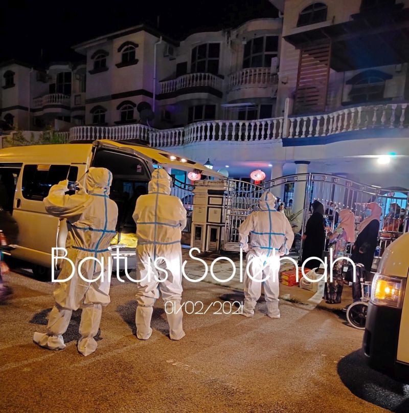 Health Ministry personnel in full personal protective equipment (PPE) suits wait to move Covid-19 positive patents at one of the Baitus Solehahu00e2u20acu02dcs premises in Skudai, Johor Baru yesterday. u00e2u20acu201d Picture via Facebook