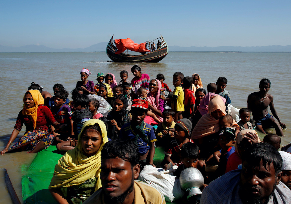 Rohingya refugees sit on a makeshift boat as they get interrogated by the Border Guard Bangladesh after crossing the Bangladesh-Myanmar border, at Shah Porir Dwip near Coxu00e2u20acu2122s Bazar, Bangladesh November 9, 2017. u00e2u20acu201d Reuters picnnn