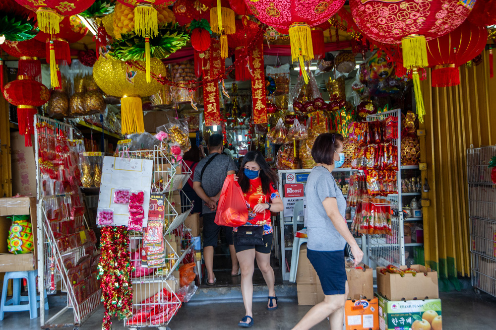 Customers walking out of religious store CYS Heong Trading Sdn Bhd in Taman Yulek, Cheras on Chinese New Year Eve, February 11, 2021. u00e2u20acu201d Picture by Shafwan Zaidon
