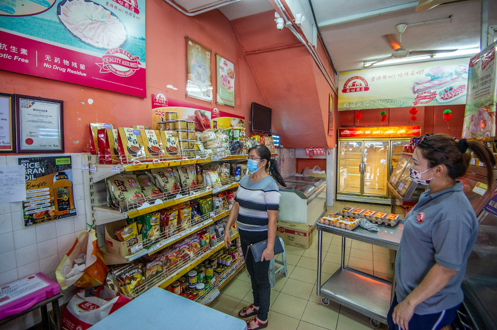 Customers browsing Chinese sausages and Bakkwa (Chinese pork jerky) at An Xin’s Healthy Meat Shoppe in Taman Yulek, Cheras on Chinese New Year Eve, February 11, 2021. — Picture by Shafwan Zaidon