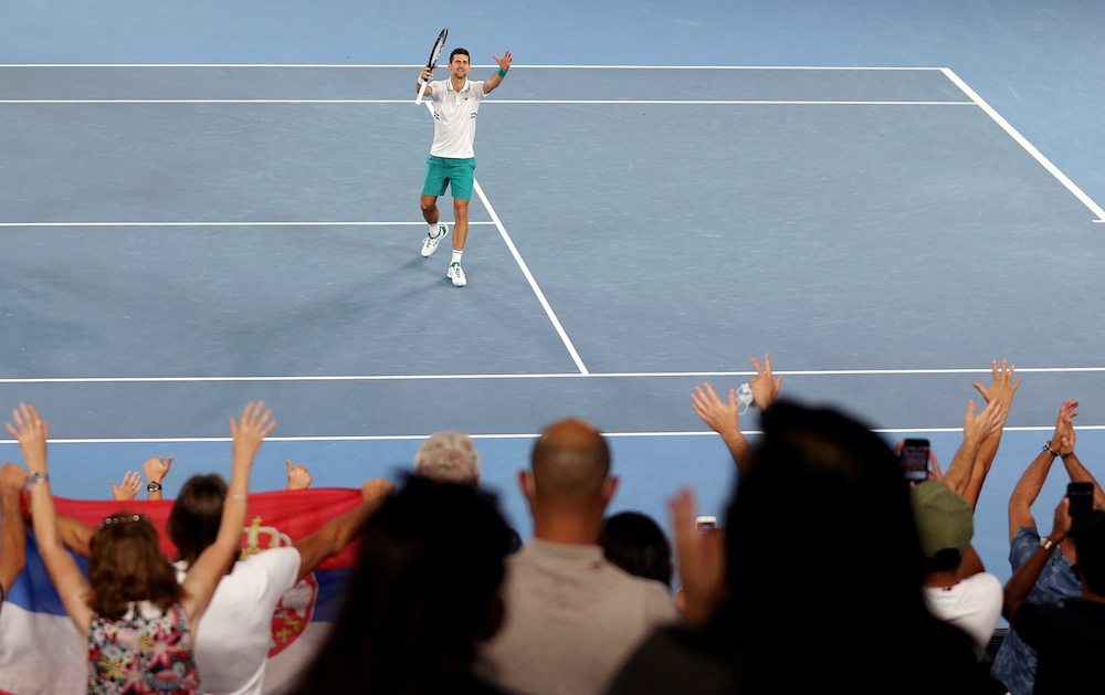 File photo of Novak Djokovic celebrating after winning his semi final match against Russia's Aslan Karatsev. Crowds return to the Australian Open today after a five-day snap lockdown was lifted following a fresh outbreak of the coronavirus disease at Melb